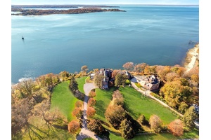 Welcome to 31 Fort Hill Drive, a landmark estate perched atop 10 private acres in the prestigious enclave of Lloyd Harbor.