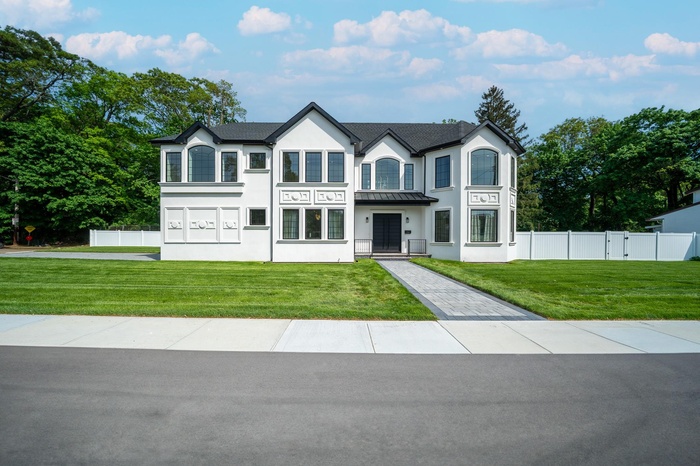 French country style house featuring stucco siding, a standing seam roof, and metal roof