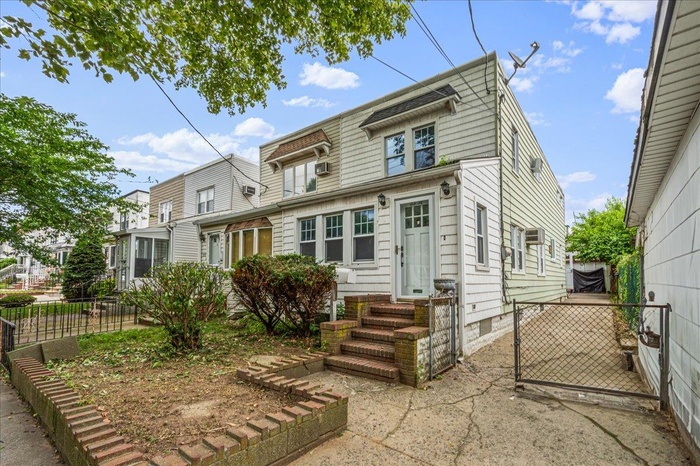 View of front of home with entry steps and a residential view