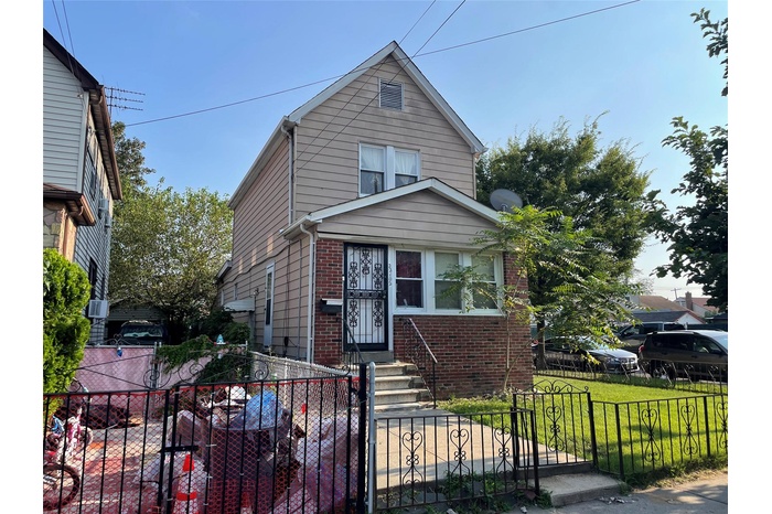 View of front of property with brick siding, a fenced front yard, a gate, and entry steps
