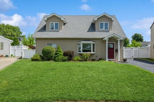 Welcome to 15 Budd Court a beautifully expanded Cape nestled on a quiet cul de sac in the heart of the Plainedge School District.
