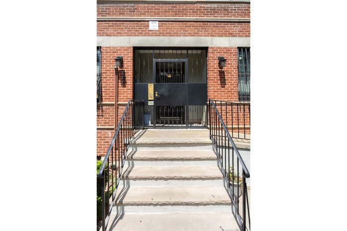 Doorway to property featuring brick siding
