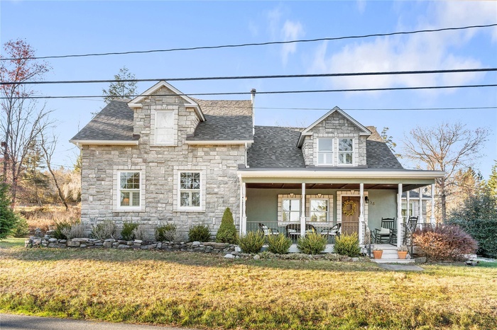 View of front facade with a front lawn and covered porch
