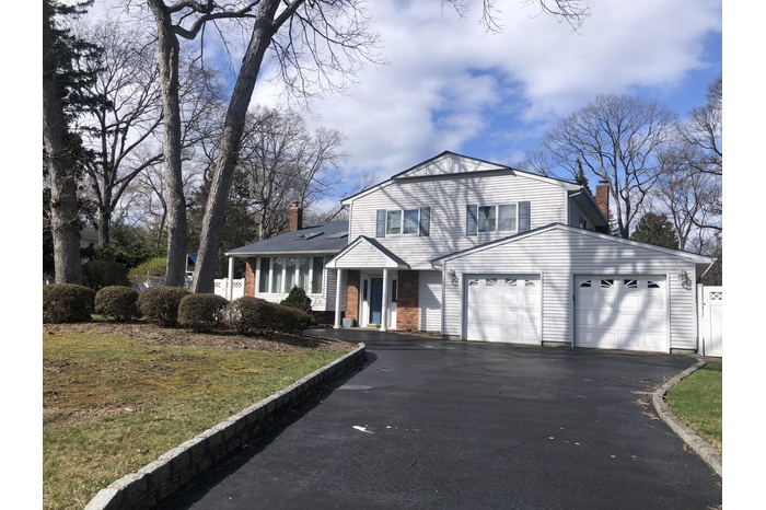 View of front of property with asphalt circular driveway