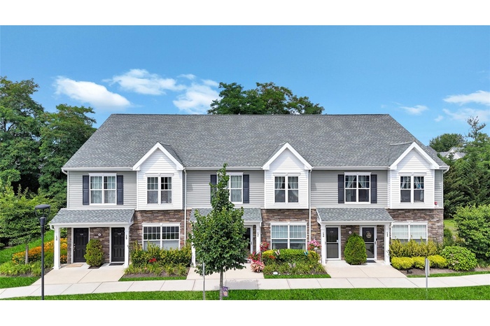 Traditional-style house with stone siding and roof with shingles