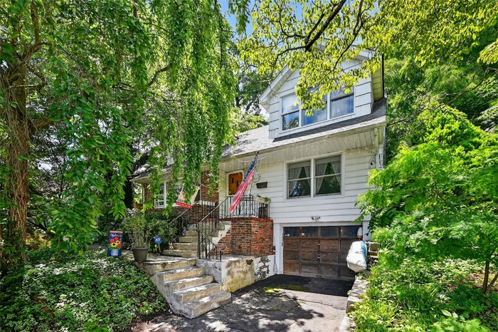View of front of property with a garage and driveway