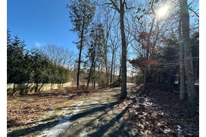Large 1. 19 acre parcel of vacant land, enjoying a beautiful location on a residential street in the heart of Woodbury.