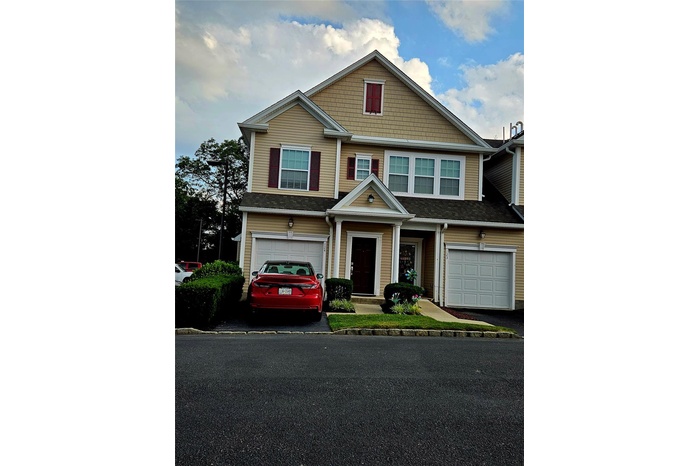 Craftsman-style home featuring a garage and driveway