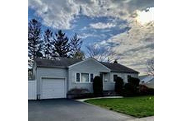 View of front of house with asphalt driveway