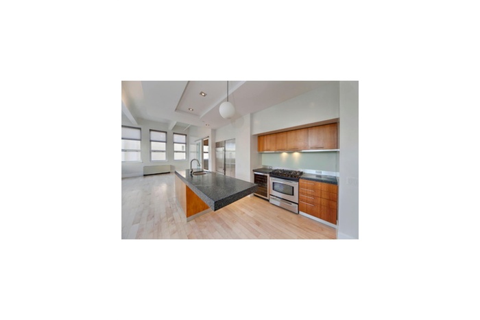 Kitchen with appliances with stainless steel finishes, modern cabinets, light wood-style floors, and open floor plan