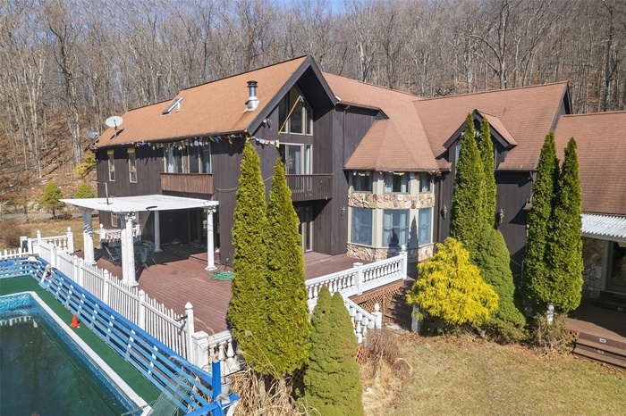 Rear view of property with a balcony and fence