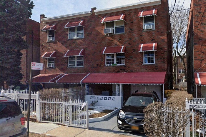 View of front of house with brick siding and cooling unit