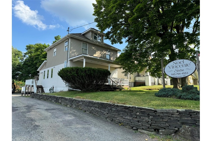 View of property exterior featuring a yard