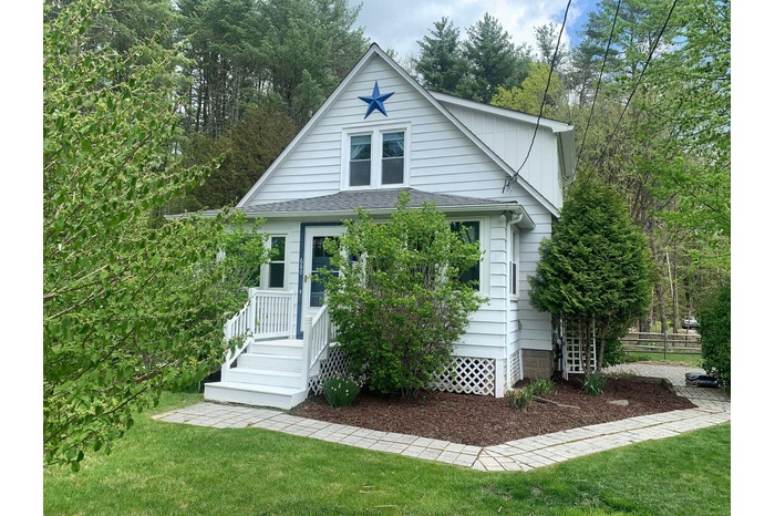 View of front of home with roof with shingles