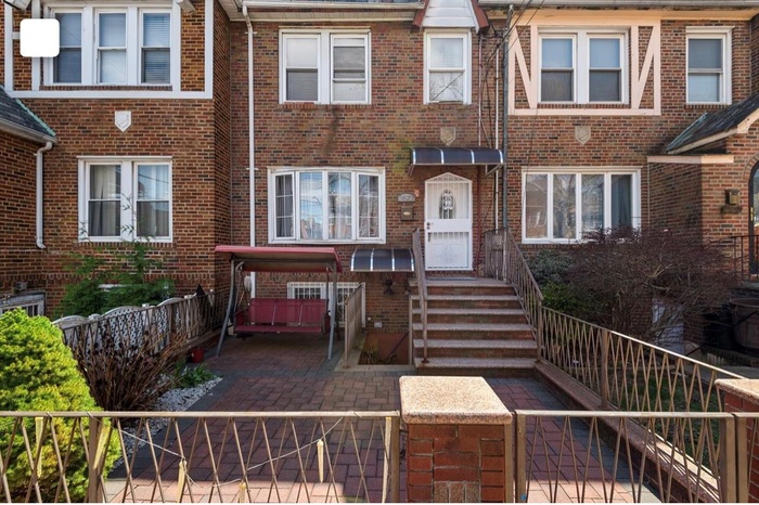 Townhome / multi-family property with fence and brick siding
