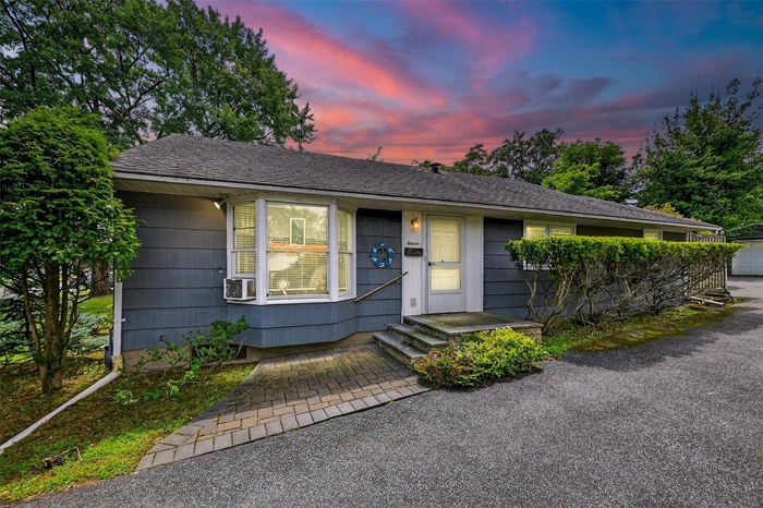 Single story home with roof with shingles