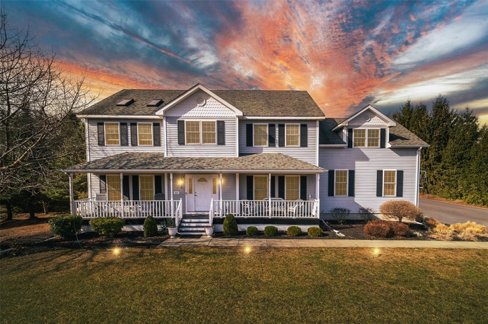 View of front of house with a porch and a front lawn