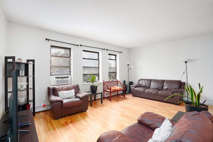 Living room with light wood finished floors and baseboards