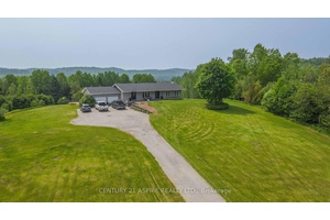 Nestled atop a picturesque hill, just over 6 acres of private property offers breathtaking views of surrounding lands and valleys just outside of quaint and charming Palmer Rapids.