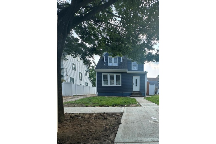 View of front facade featuring entry steps and a shingled roof
