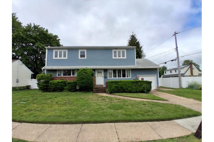 View of front of property with a garage and concrete driveway