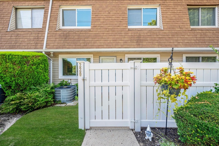 Doorway to property with a gate and roof with shingles