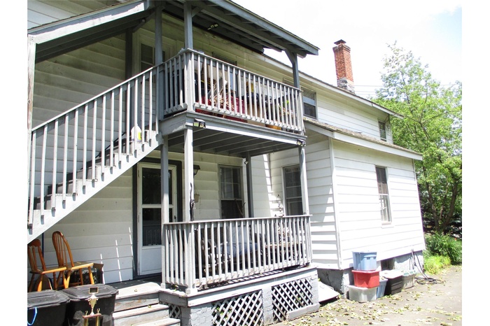 Side porch ..kitchen entrance wuth outside stairs to second level