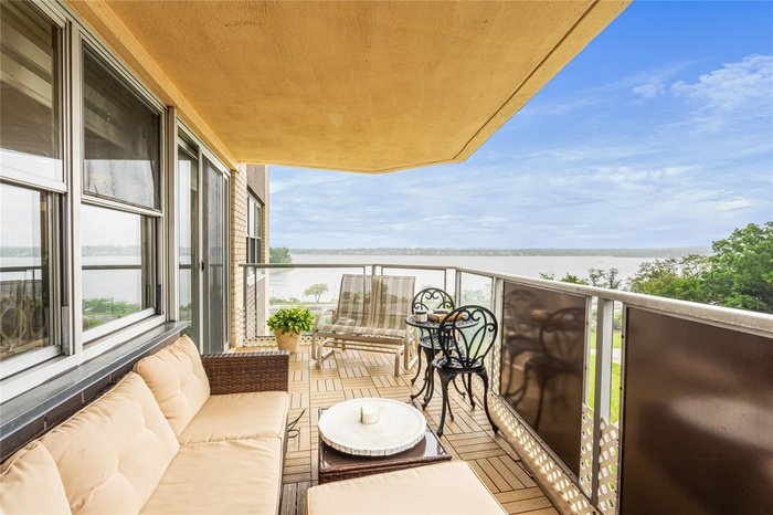Balcony with a water view and an outdoor living space