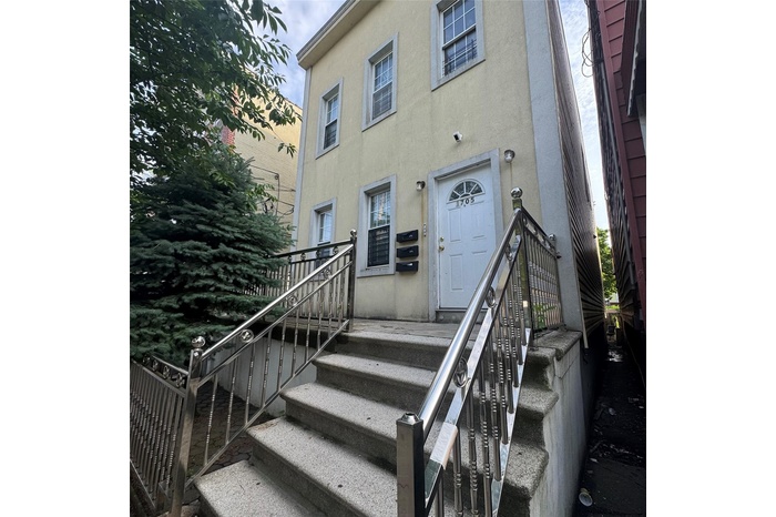 Entrance to property with stucco siding