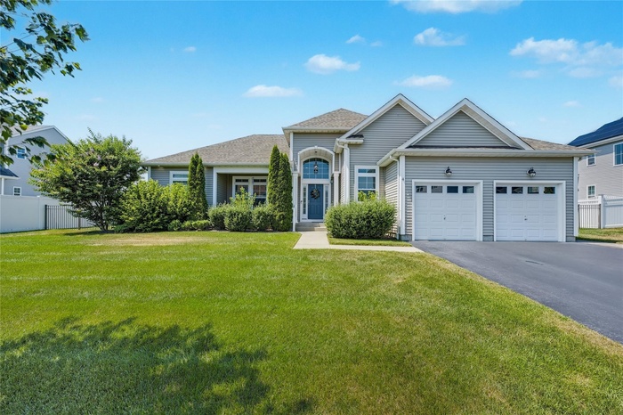 View of front of house featuring an attached garage and driveway
