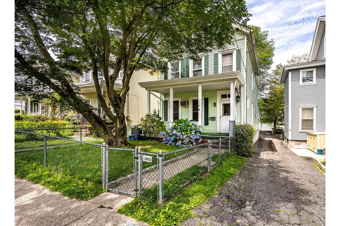 Front covered porch, fenced-in yard, and a gate to sidewalks