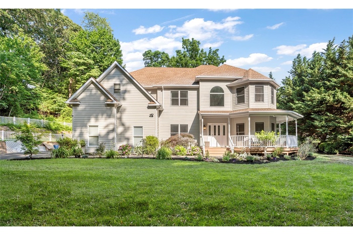 View of front of property with a porch and a shingled roof