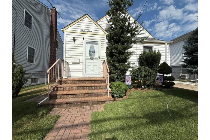 View of front of property with entry steps and a front yard