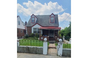 Detached 2 family Cape Cod that sits on nice lot that offers off street parking.