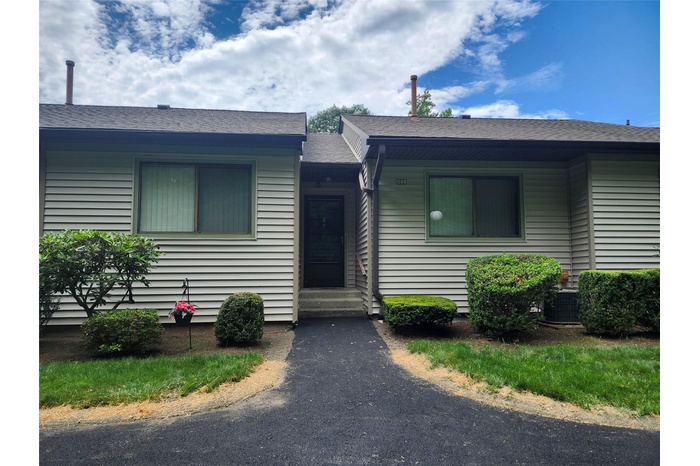 View of front of property featuring entry steps and roof with shingles