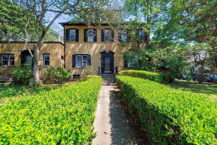 Colonial house featuring brick siding