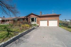 This spacious double garage bungalow offers the rare convenience of a main level primary ensuite and backs directly onto Connaught Park with no rear neighbours.