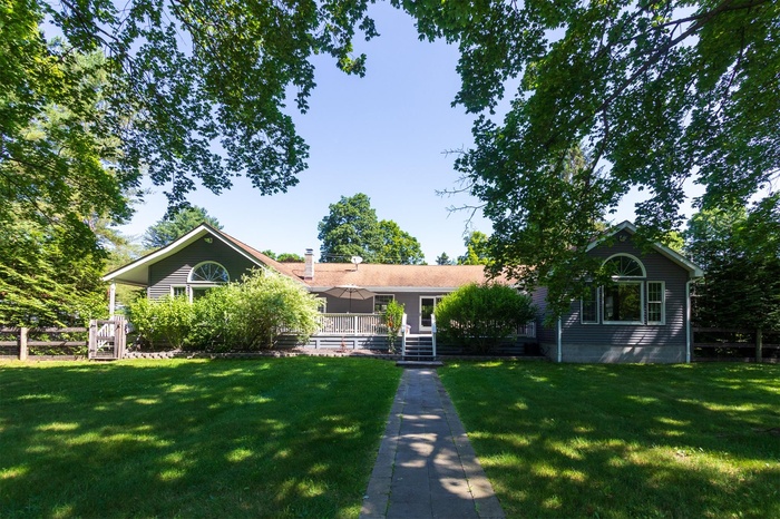 View of front of home with a front lawn and a chimney