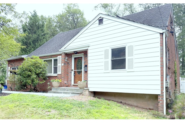 Cape/Colonal Styled  home, 11 Rooms in Total.  Featuring a shingled roof, a front lawn, and brick siding on 1/2 Acre of Land