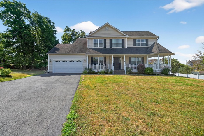 View of front of house featuring a wrap around front porch with gazebo and 2 garage