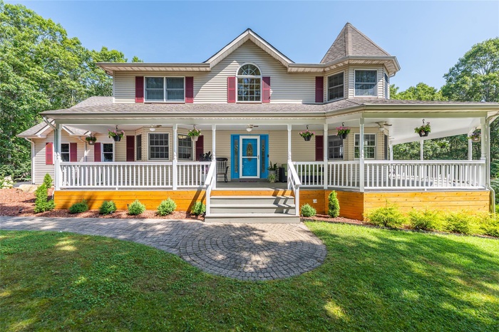 Wrap around porch featuring outdoor fans