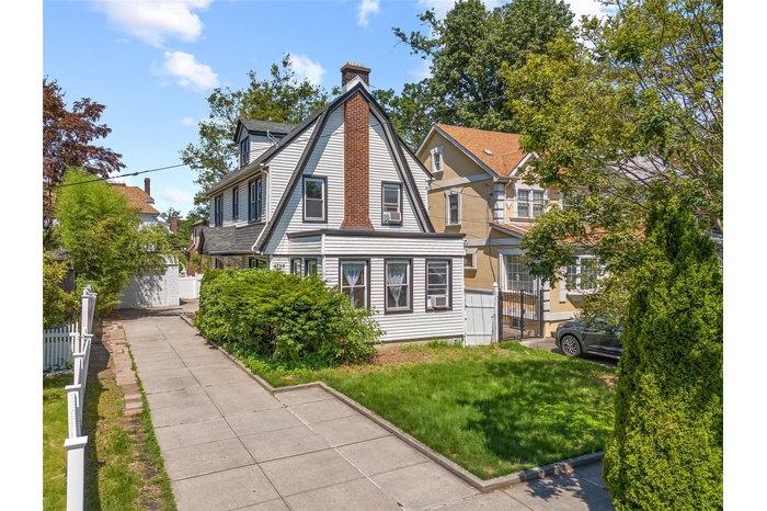 View of front of home featuring a chimney
