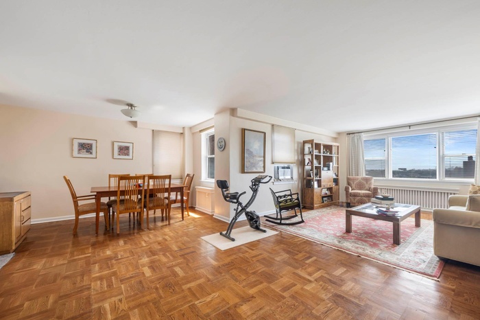 Living area featuring baseboards and radiator