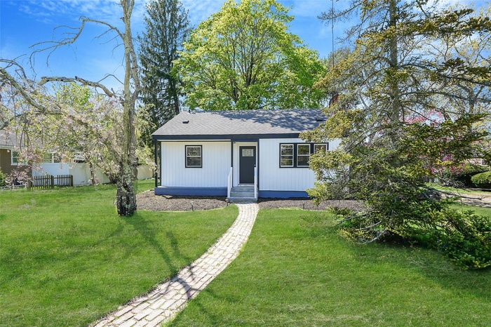 Bungalow-style house with a shingled roof, fence, a front yard, and entry steps