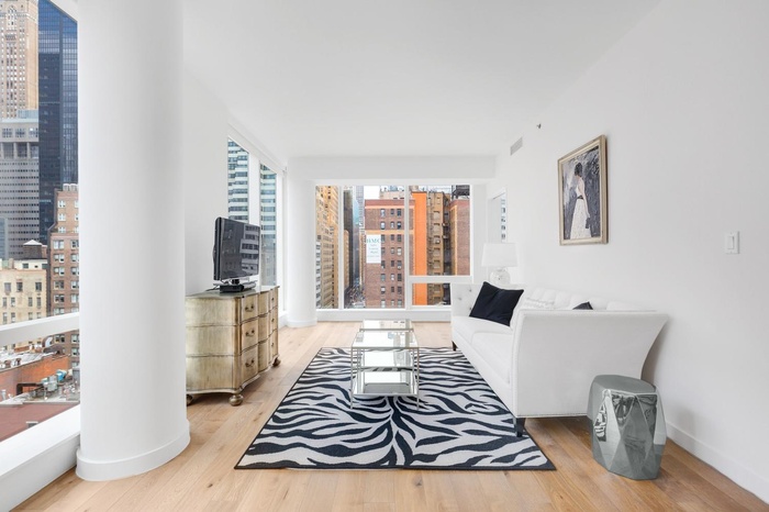 Living area featuring light wood-style flooring and a city view