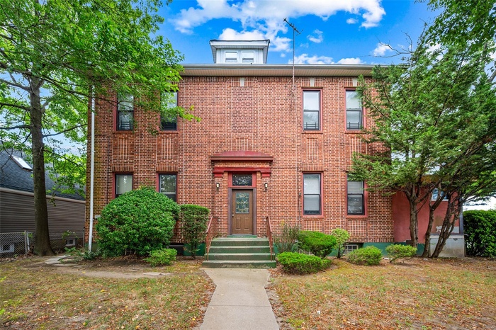 View of front of house featuring brick siding