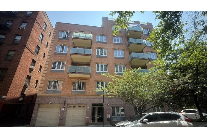 View of apartment building / complex with a garage