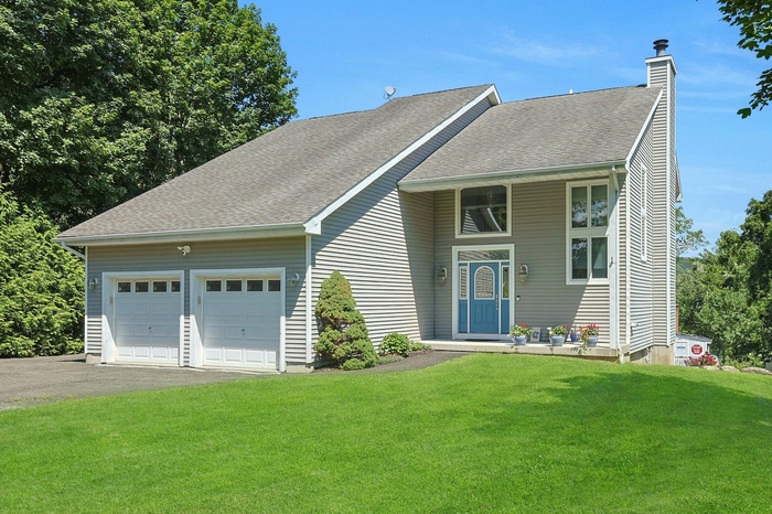 Showcasing a lovely design, this custom contemporary is very deceiving from the front. Check out the next photo and all it has to offer!