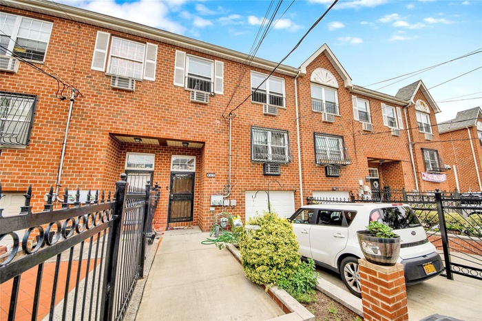 Townhome / multi-family property featuring brick siding and a gate