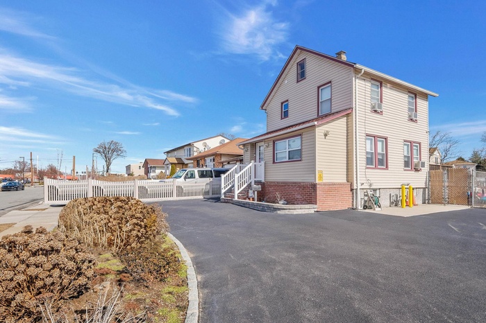 View of home's exterior with a residential view and asphalt driveway